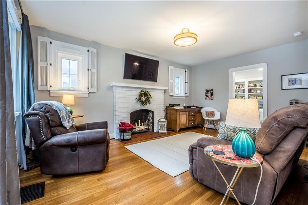 105 Fahnestock Road Pittsburgh, PA 15215 - Photo 8 of 20 a living room with furniture a fireplace and a flat screen tv