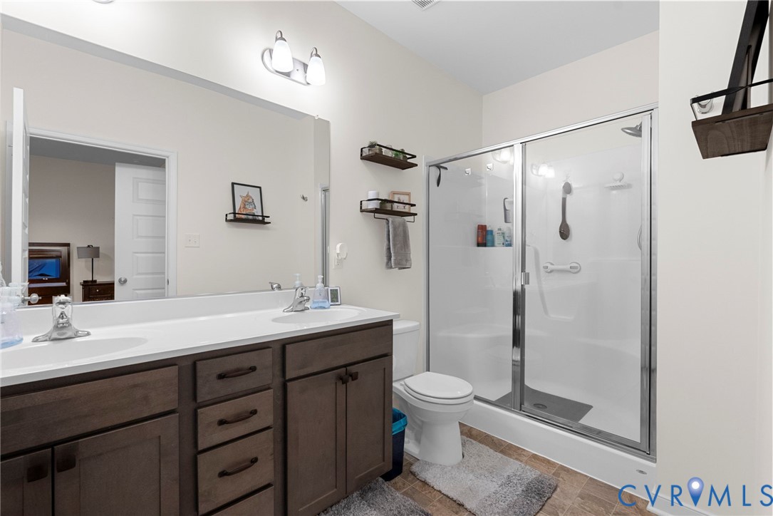 48 James Court Aylett, VA 23009 - Photo 20 of 30 a bathroom with a double vanity sink toilet mirror and shower