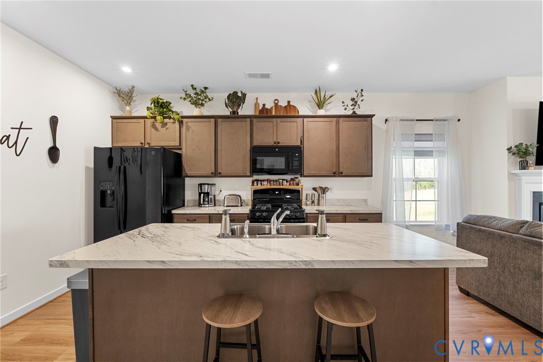 48 James Court Aylett, VA 23009 - Photo 10 of 30 a kitchen with stainless steel appliances a dining table and chairs