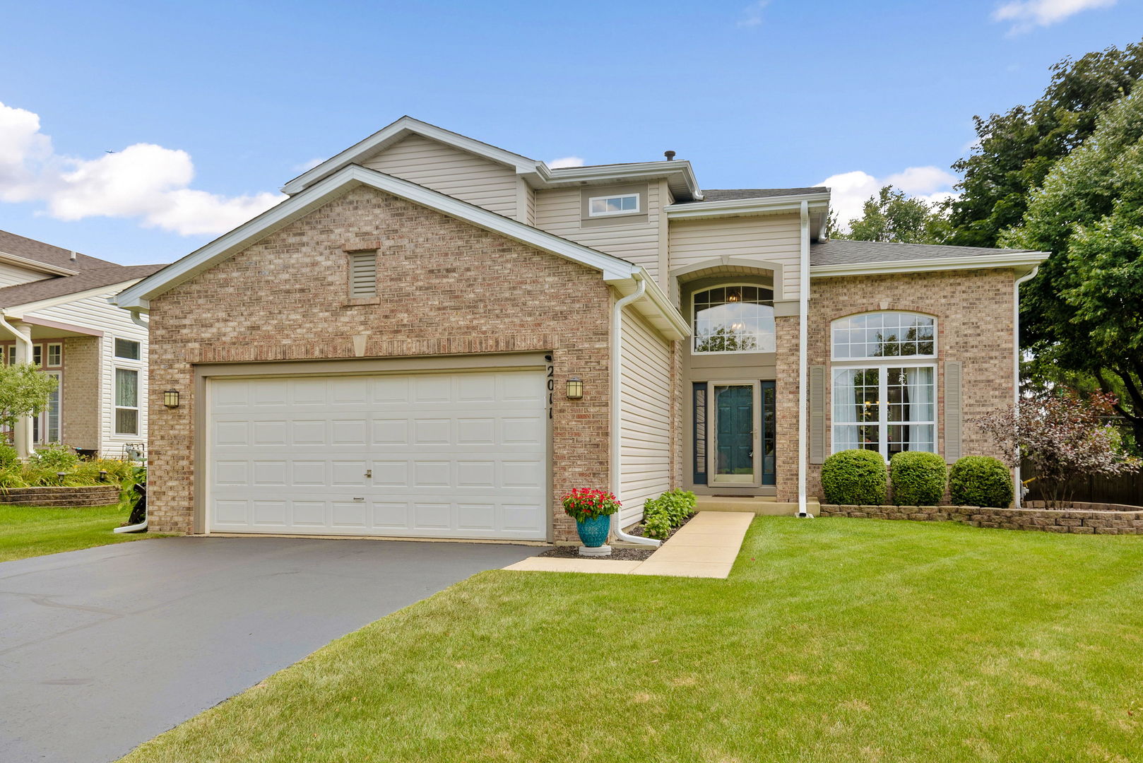 2011 Baldwin Way Bolingbrook, IL 60490 - Photo 21 of 21 a front view of a house with a yard and garage
