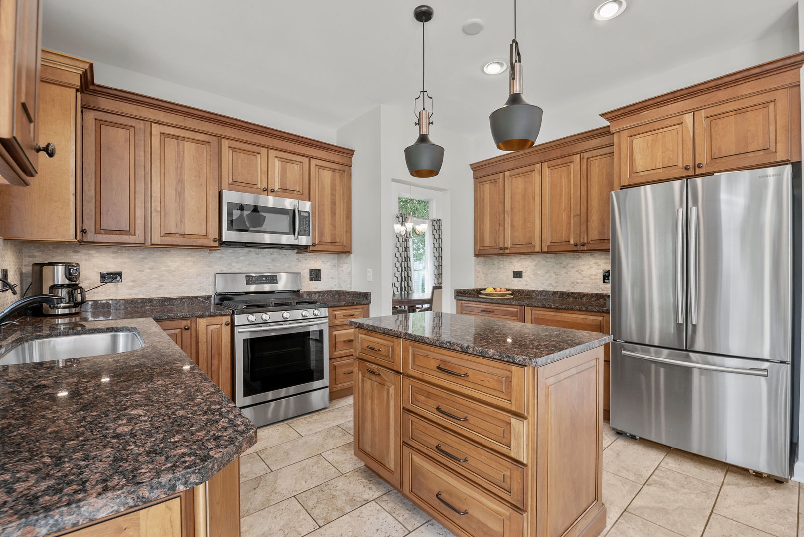 2011 Baldwin Way Bolingbrook, IL 60490 - Photo 5 of 21 a kitchen with stainless steel appliances granite countertop a stove sink microwave and refrigerator