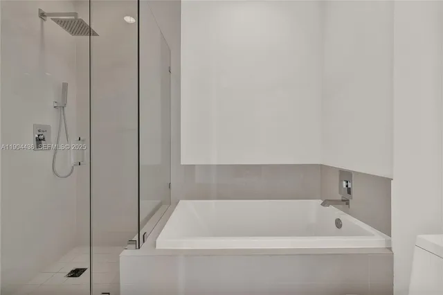 a bathroom with a tub and a shower