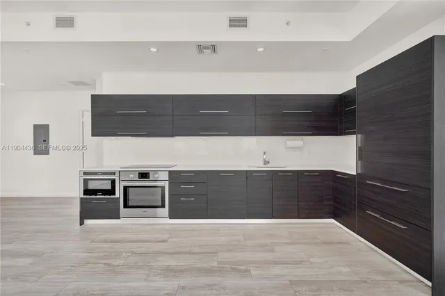 a view of kitchen with microwave and cabinets