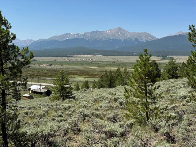 a view of a town with mountains in the background