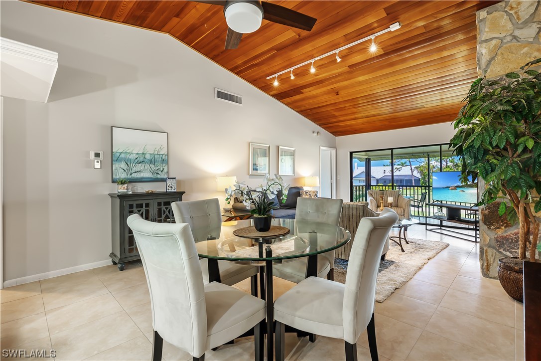 16650 Partridge Place Road, Unit 201 Fort Myers, FL 33908 - Photo 1 of 32 a dining room with furniture garden view and a potted plant