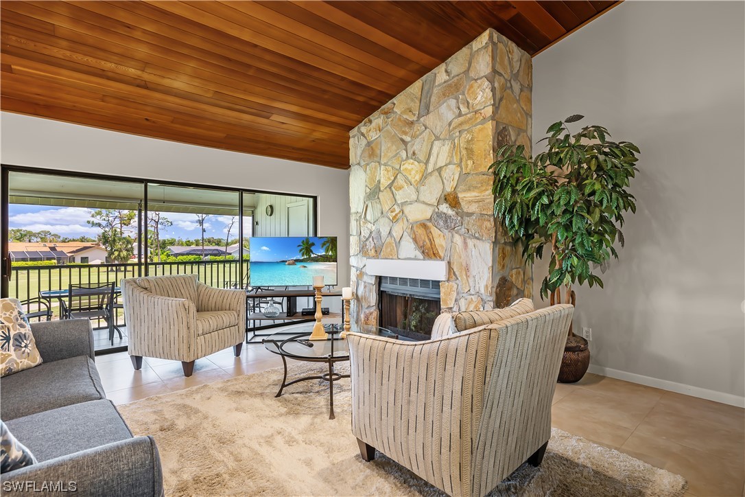 16650 Partridge Place Road, Unit 201 Fort Myers, FL 33908 - Photo 12 of 32 a living room with furniture and a fireplace