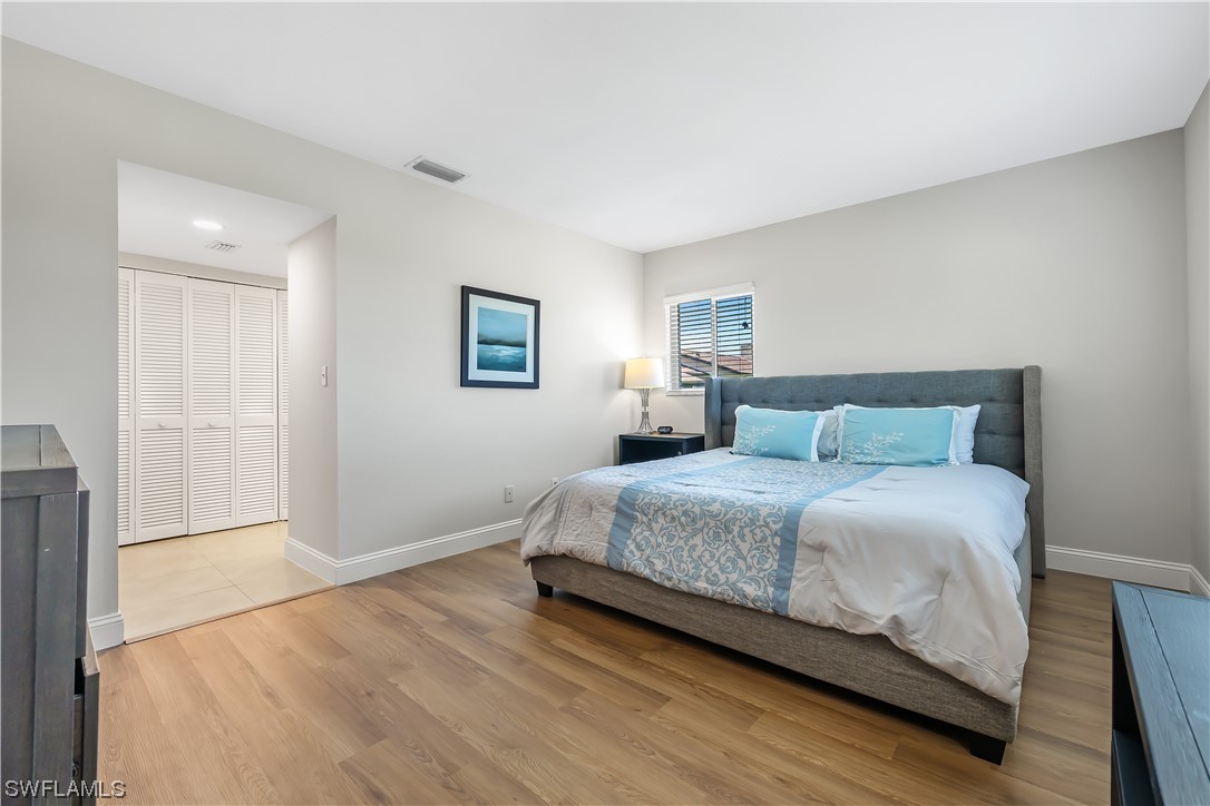 16650 Partridge Place Road, Unit 201 Fort Myers, FL 33908 - Photo 16 of 32 a bedroom with a bed and a night stand
