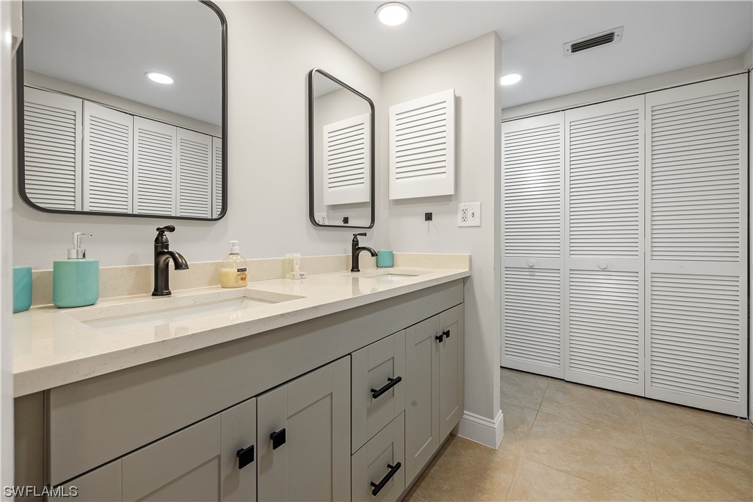 16650 Partridge Place Road, Unit 201 Fort Myers, FL 33908 - Photo 18 of 32 a bathroom with double sink and a mirror