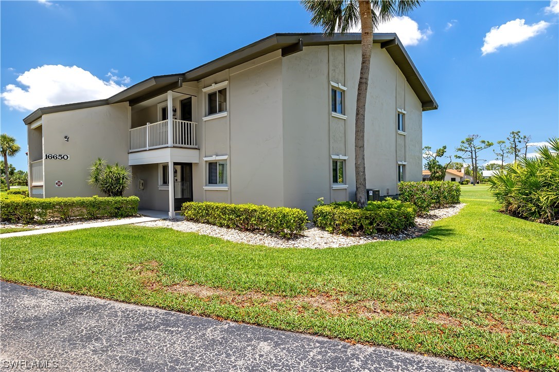 16650 Partridge Place Road, Unit 201 Fort Myers, FL 33908 - Photo 2 of 32 a front view of house with yard