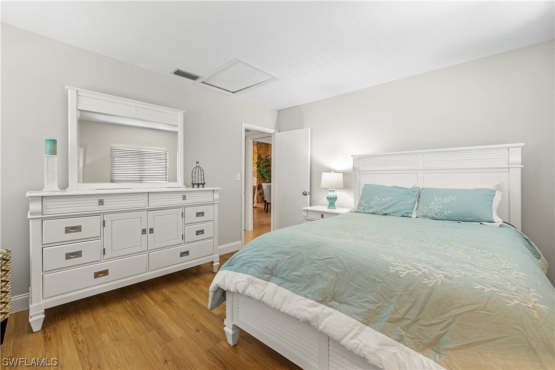 16650 Partridge Place Road, Unit 201 Fort Myers, FL 33908 - Photo 23 of 32 a bedroom with a large bed and a dresser