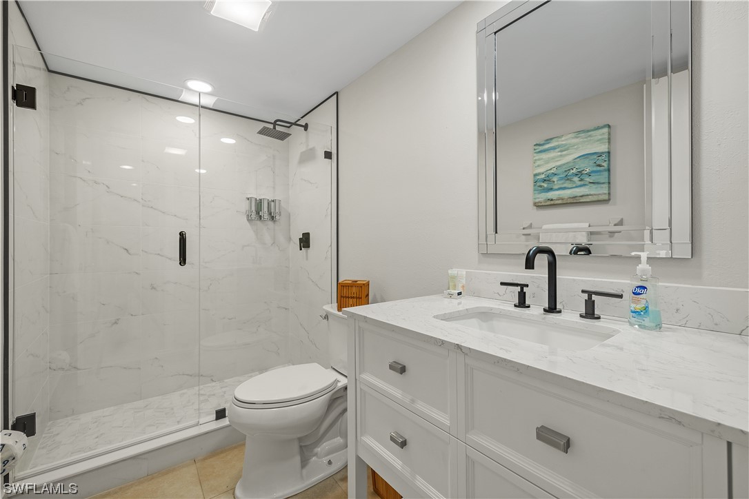 16650 Partridge Place Road, Unit 201 Fort Myers, FL 33908 - Photo 25 of 32 a bathroom with a sink a toilet and shower