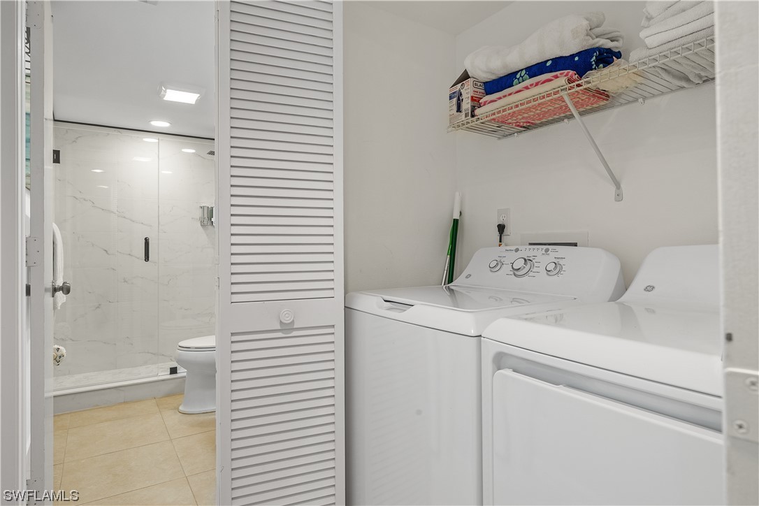 16650 Partridge Place Road, Unit 201 Fort Myers, FL 33908 - Photo 26 of 32 a utility room with dryer and washer