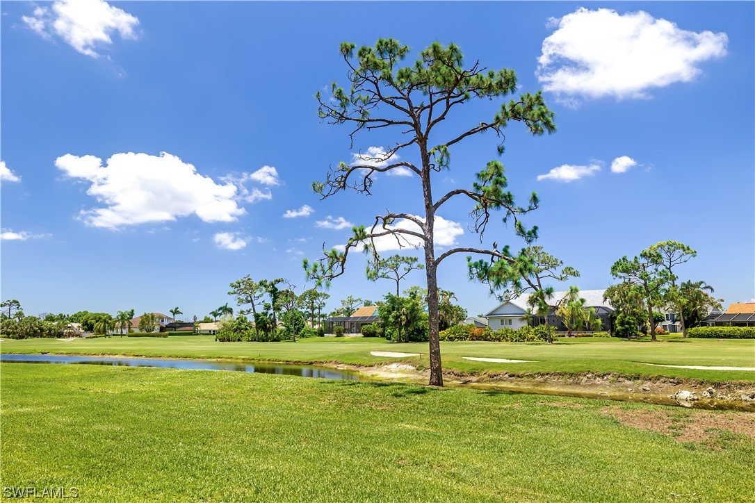 16650 Partridge Place Road, Unit 201 Fort Myers, FL 33908 - Photo 28 of 32 a view of a golf course with a lake