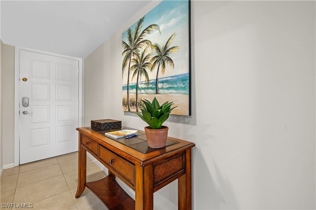 16650 Partridge Place Road, Unit 201 Fort Myers, FL 33908 - Photo 3 of 32 a table room with a table and a potted plant