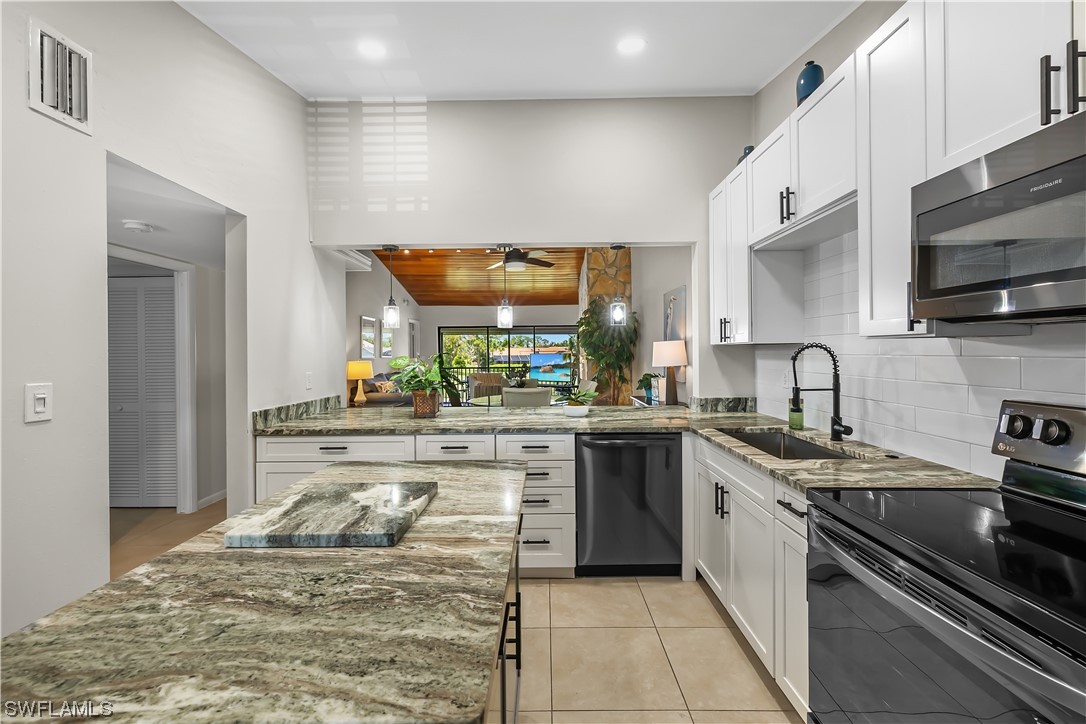 16650 Partridge Place Road, Unit 201 Fort Myers, FL 33908 - Photo 7 of 32 a kitchen with stainless steel appliances granite countertop a sink stove and cabinets