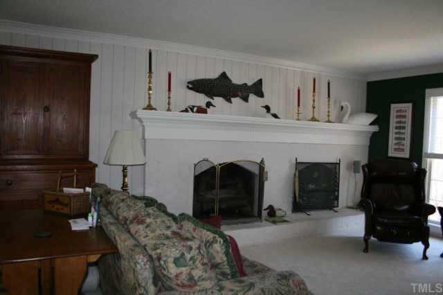 10009 Bavin Place Raleigh, NC 27613 - Photo 3 of 10 a living room with furniture and a fireplace