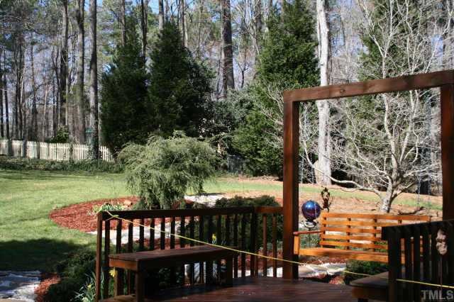 10009 Bavin Place Raleigh, NC 27613 - Photo 10 of 10 a view of a wooden deck with a yard