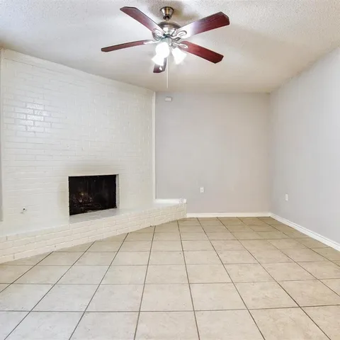 a view of a livingroom with a fan and a fireplace