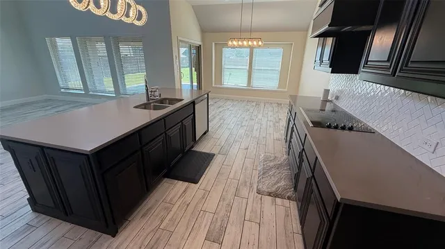 a kitchen with sink cabinets and wooden floor