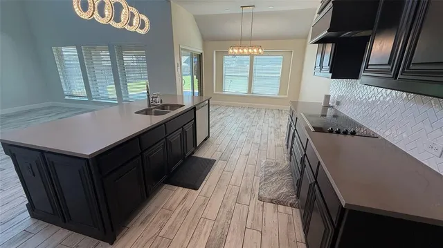 a kitchen with wooden cabinets and sink