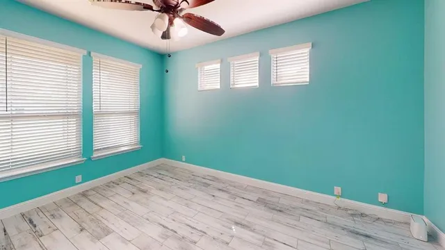 a view of a room with a ceiling fan and a window