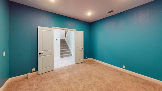 a view of a room with stairs and a wooden floor