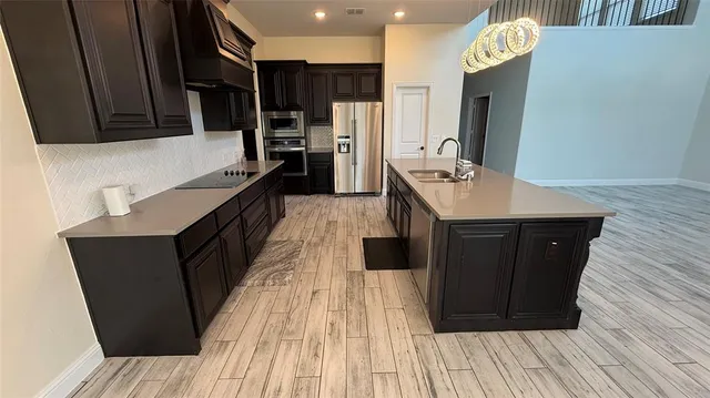 a kitchen with wooden cabinets and a stainless steel appliances
