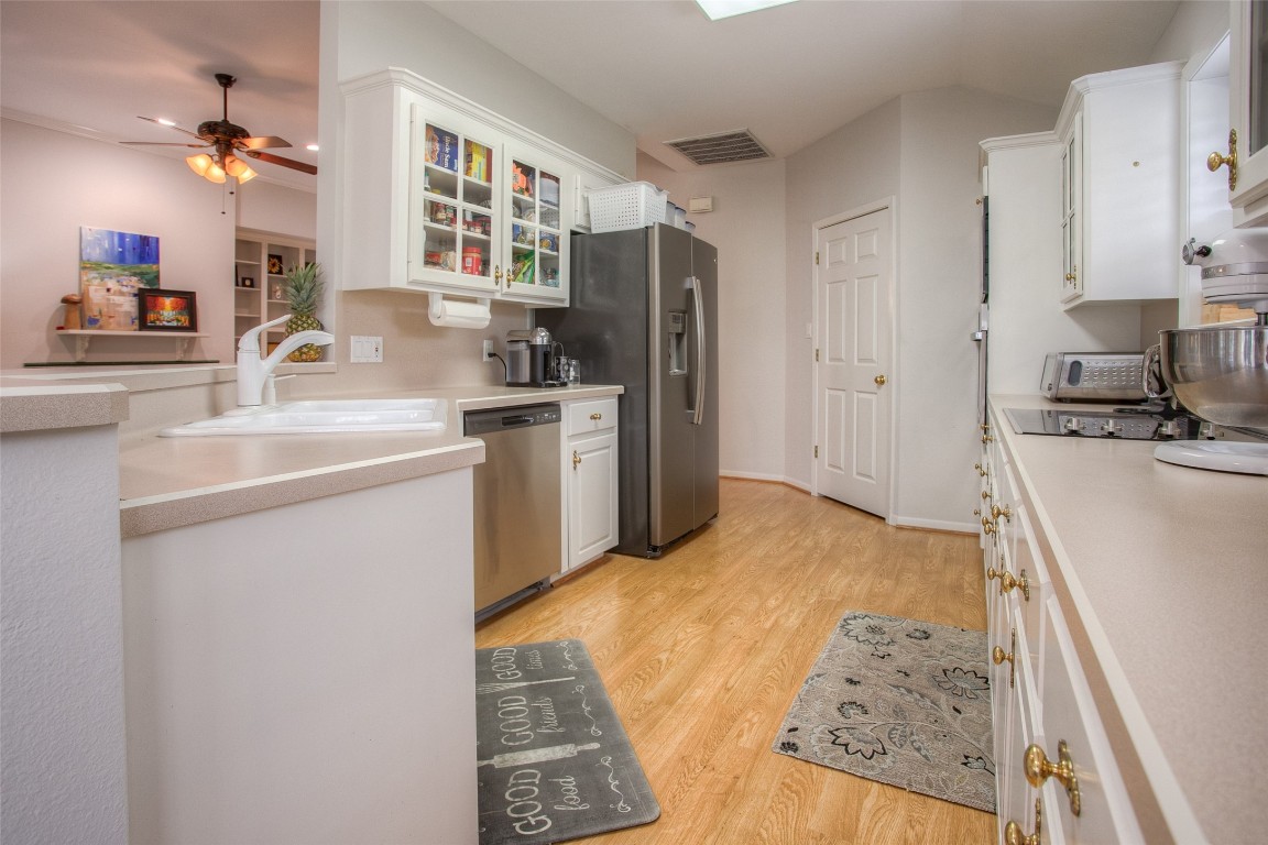134 Waters Edge Huntsville, TX 77340 - Photo 23 of 38 a kitchen with stainless steel appliances granite countertop a sink stove and refrigerator