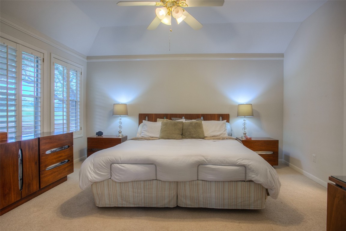 134 Waters Edge Huntsville, TX 77340 - Photo 27 of 38 a bedroom with a bed and a chandelier