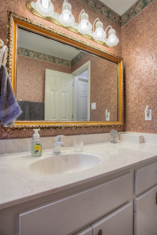 134 Waters Edge Huntsville, TX 77340 - Photo 34 of 38 a bathroom with a sink and a mirror