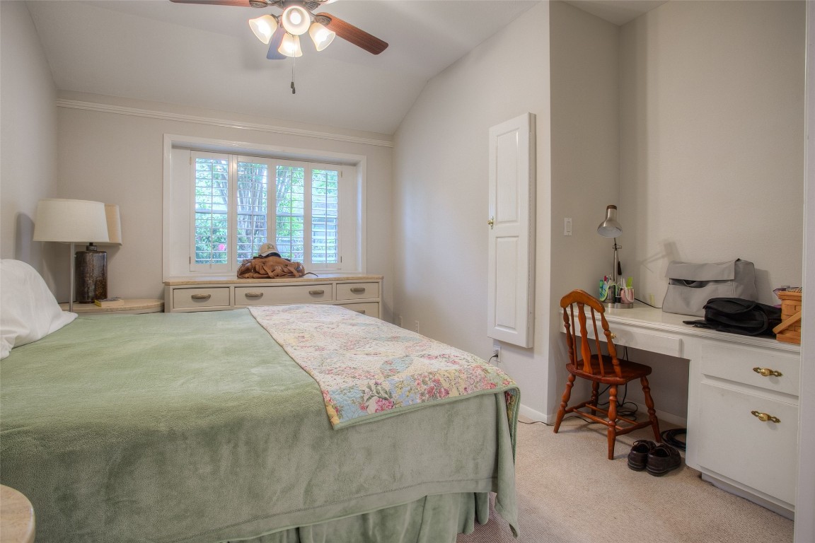 134 Waters Edge Huntsville, TX 77340 - Photo 35 of 38 a bedroom with a bed and a chandelier