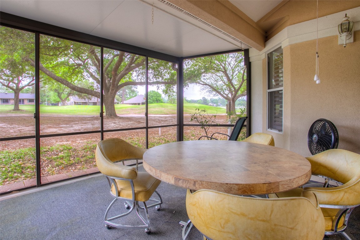 134 Waters Edge Huntsville, TX 77340 - Photo 6 of 38 a view of a dining room with furniture wooden floor and a floor to ceiling window