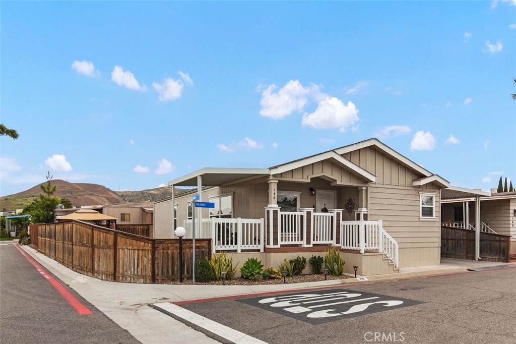 4901 Green River Road, Unit 148 Corona, CA 92878 - Photo 1 of 1 a front view of a house with a yard