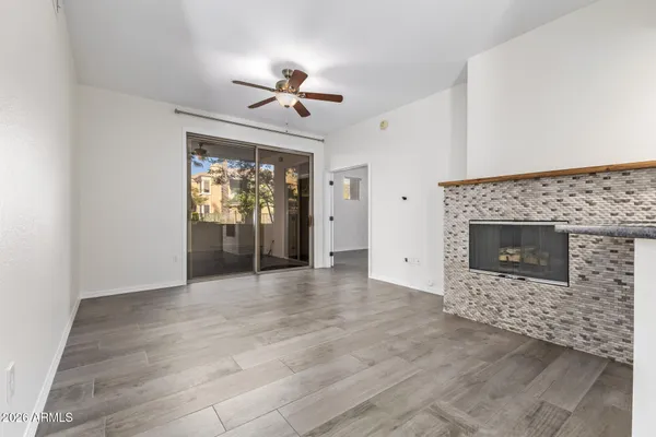 a view of an empty room with a fireplace