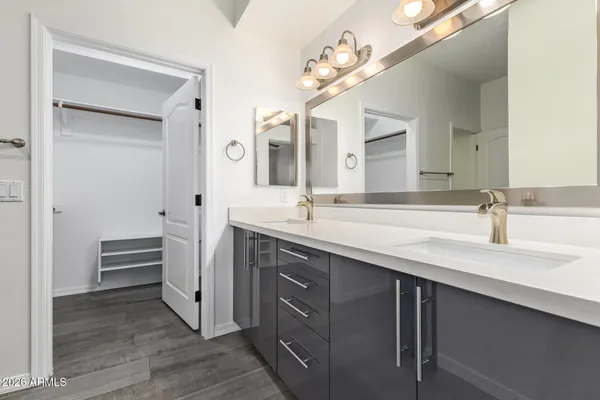 a bathroom with a double vanity sink a vanity and a mirror