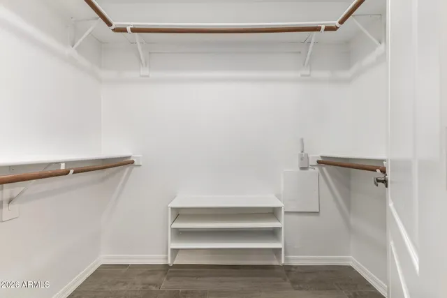 a view of walk in closet with empty racks