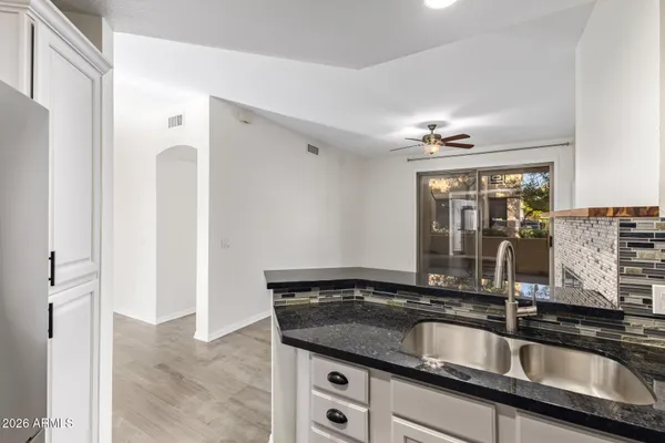 a close view of a sink a counter top space and utility room