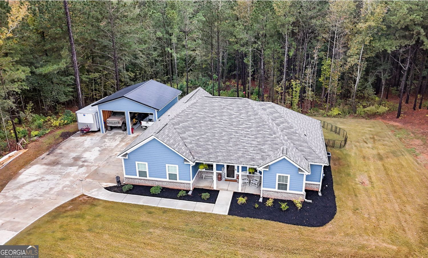 an aerial view of a house with a yard patio and backyard