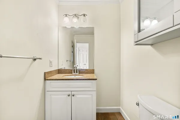 a bathroom with a sink a toilet and a mirror
