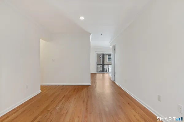 a view of a room with wooden floor and stairs