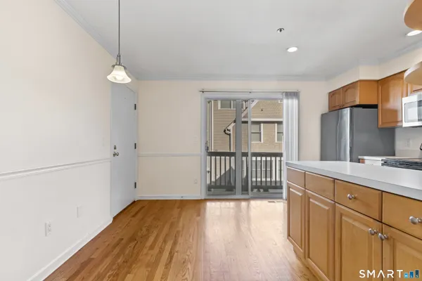 a view of a kitchen with a sink and wooden floor