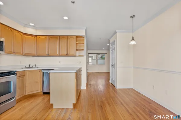 a kitchen with a refrigerator and a stove top oven