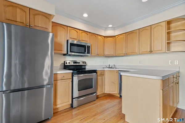 a kitchen with stainless steel appliances a refrigerator stove microwave and sink