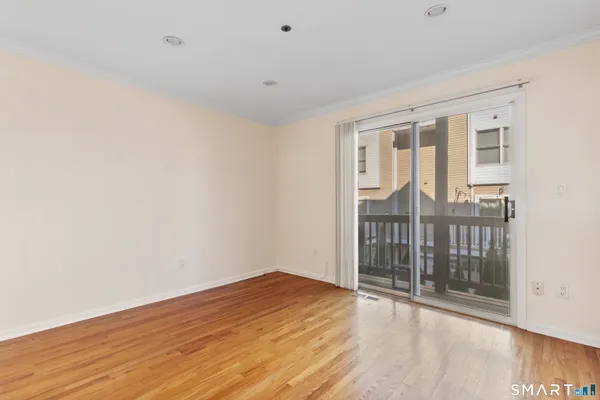 a view of empty room with wooden floor