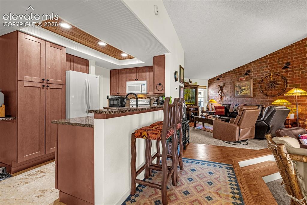 1658 Deer Creek Road Monument, CO 80132 - Photo 9 of 21 Beautifully updated kitchen with breakfast bar, ample storage and inset lighting