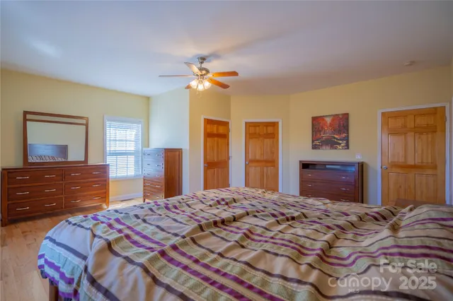a bedroom with a bed dresser and a large mirror