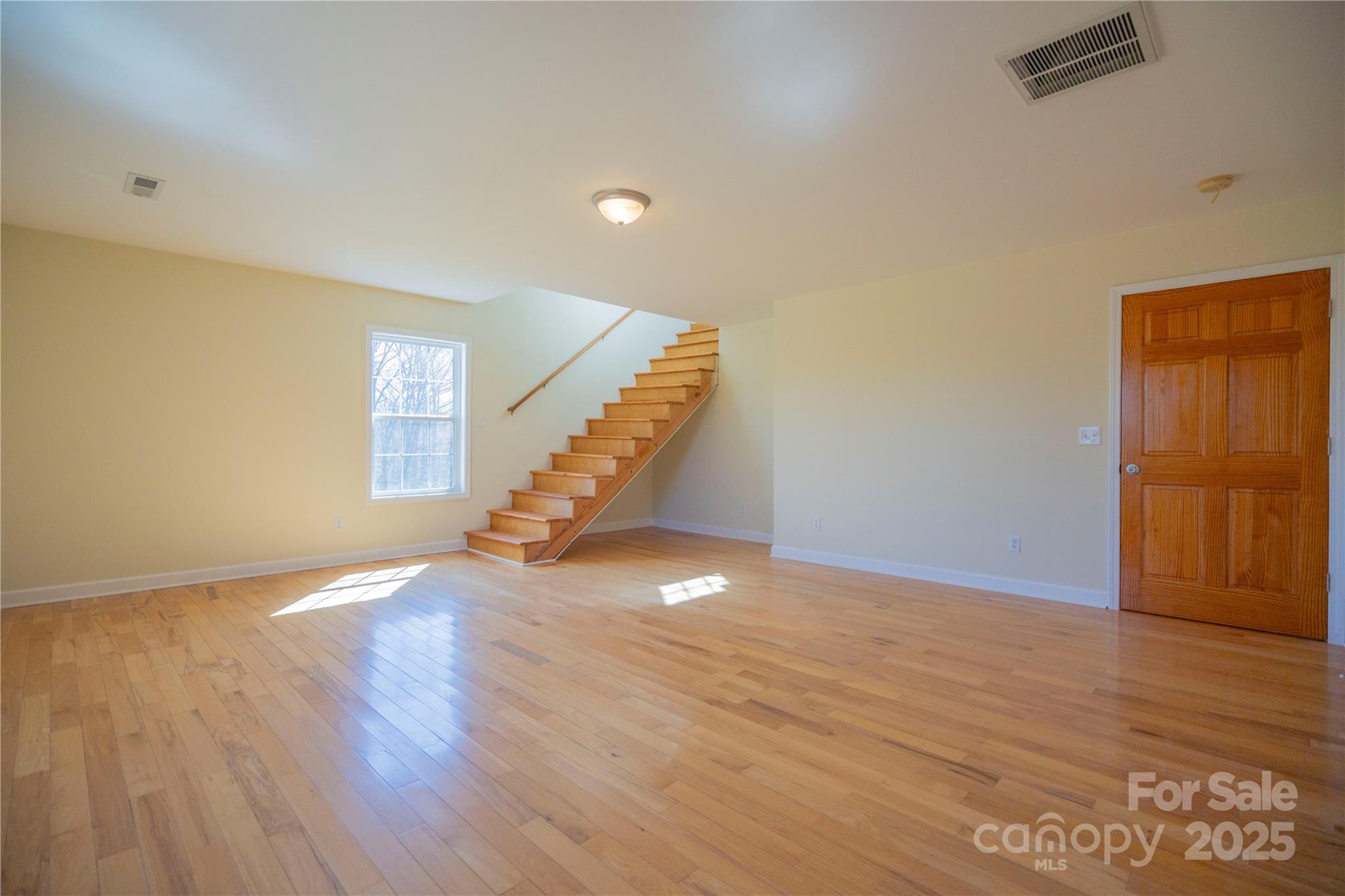 2536 Tyro Road Lexington, NC 27295 - Photo 20 of 31 a view of an empty room with wooden floor and stairs