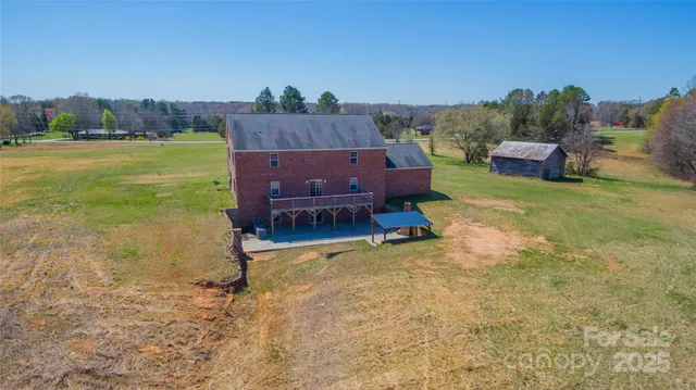 a wooden bench sitting in the middle of a yard