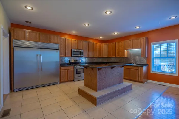 a kitchen with granite countertop a stove and cabinets