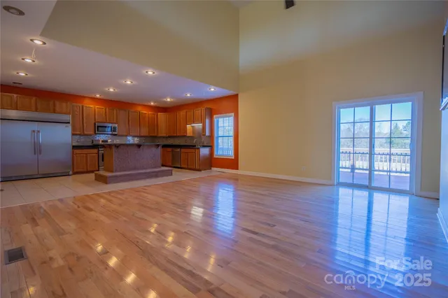 a view of kitchen with sink and refrigerator